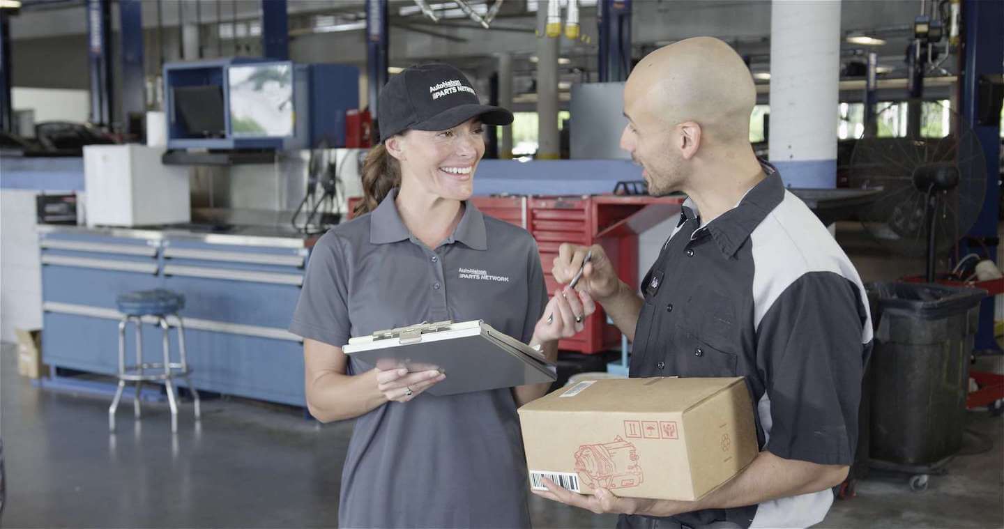 AutoNation Parts Network team member delivering parts to a happy customer